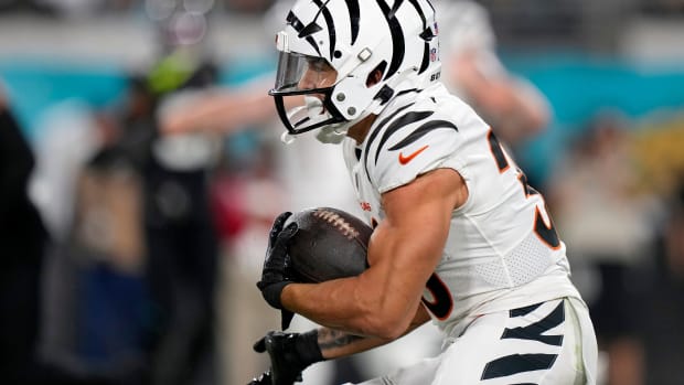 Cincinnati Bengals running back Chase Brown (30) takes a carry from Cincinnati Bengals quarterback Jake Browning (6) in the first half of a Week 13 NFL football game against the Jacksonville Jaguars, Monday, Dec. 4, 2023, at EverBank Stadium in Jacksonville, Fla.